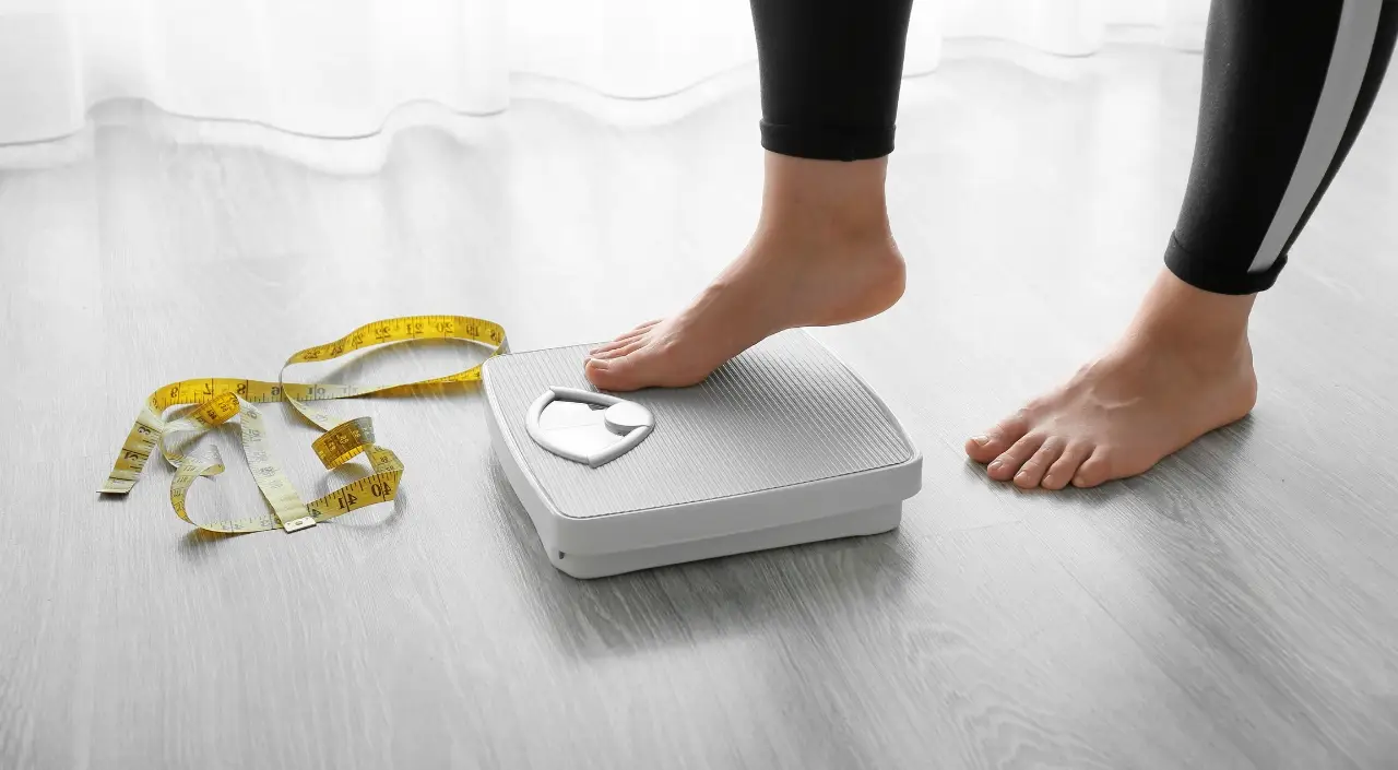 weight loss image, woman standing on a scale